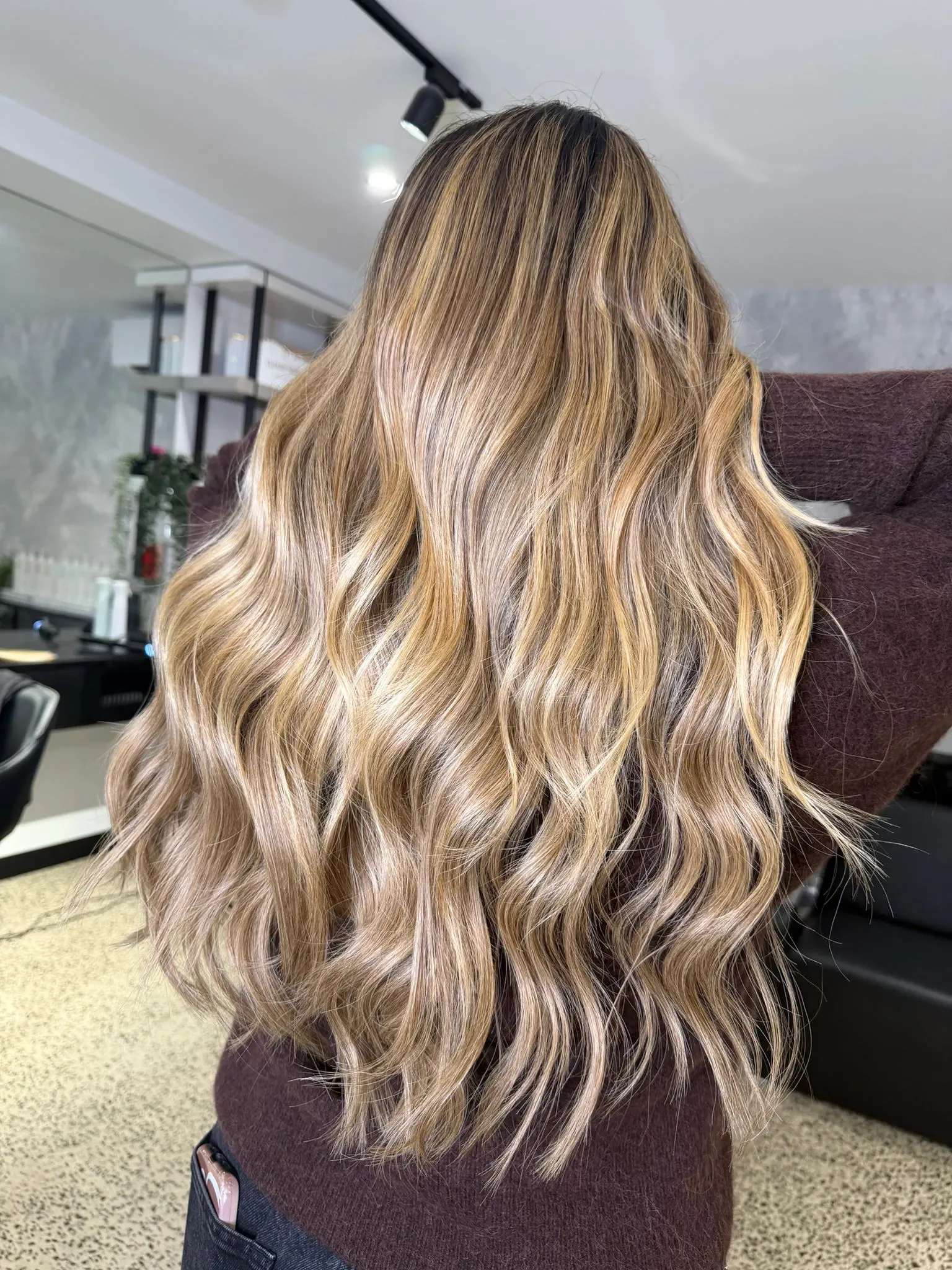 Long, wavy blonde MARE X Salon Ayre hair extensions styled at Salon Ayre, Mentone VIC