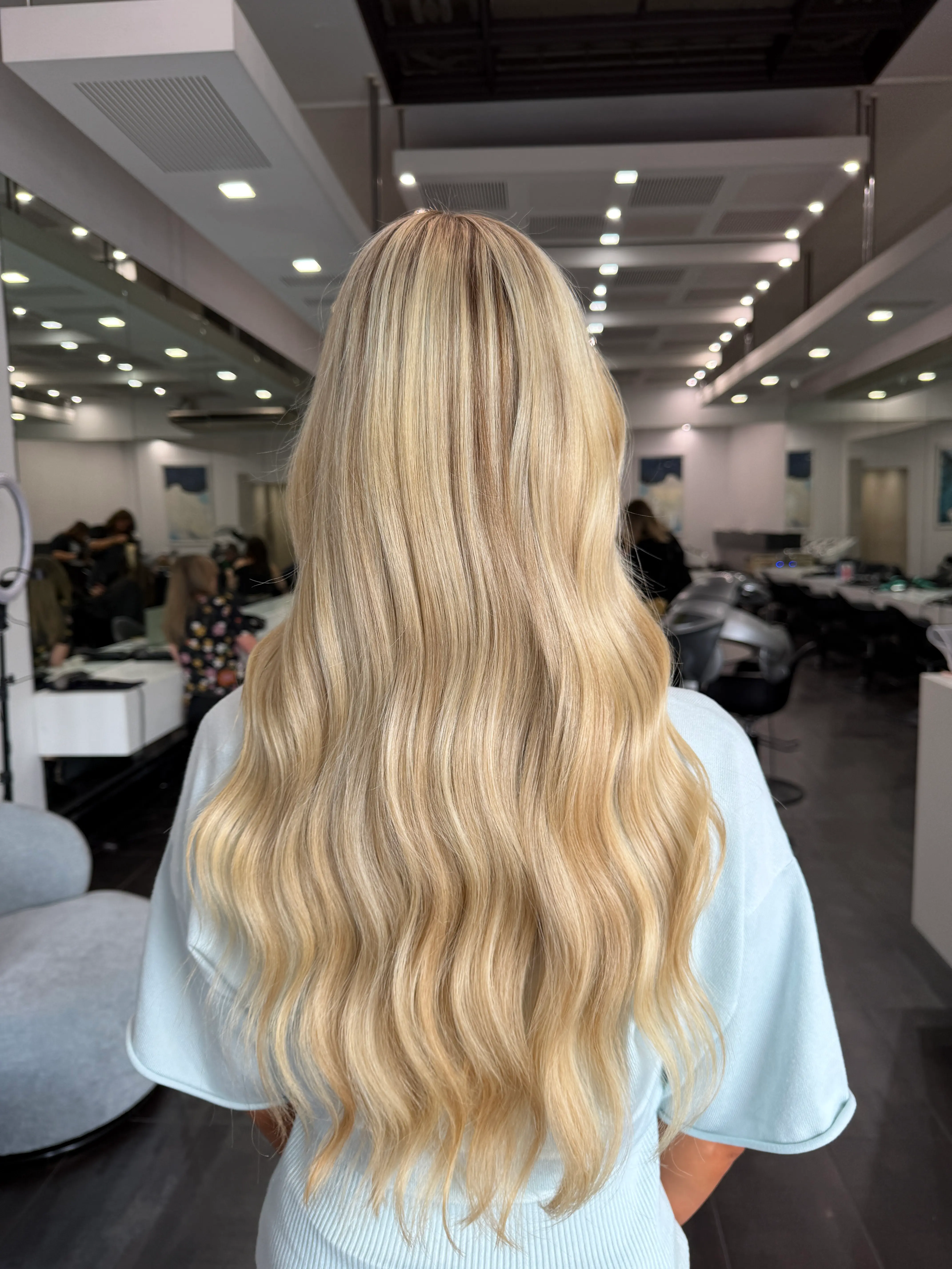 Long blonde hair with soft waves after a professional blowdry at Salon Ayre Mentone