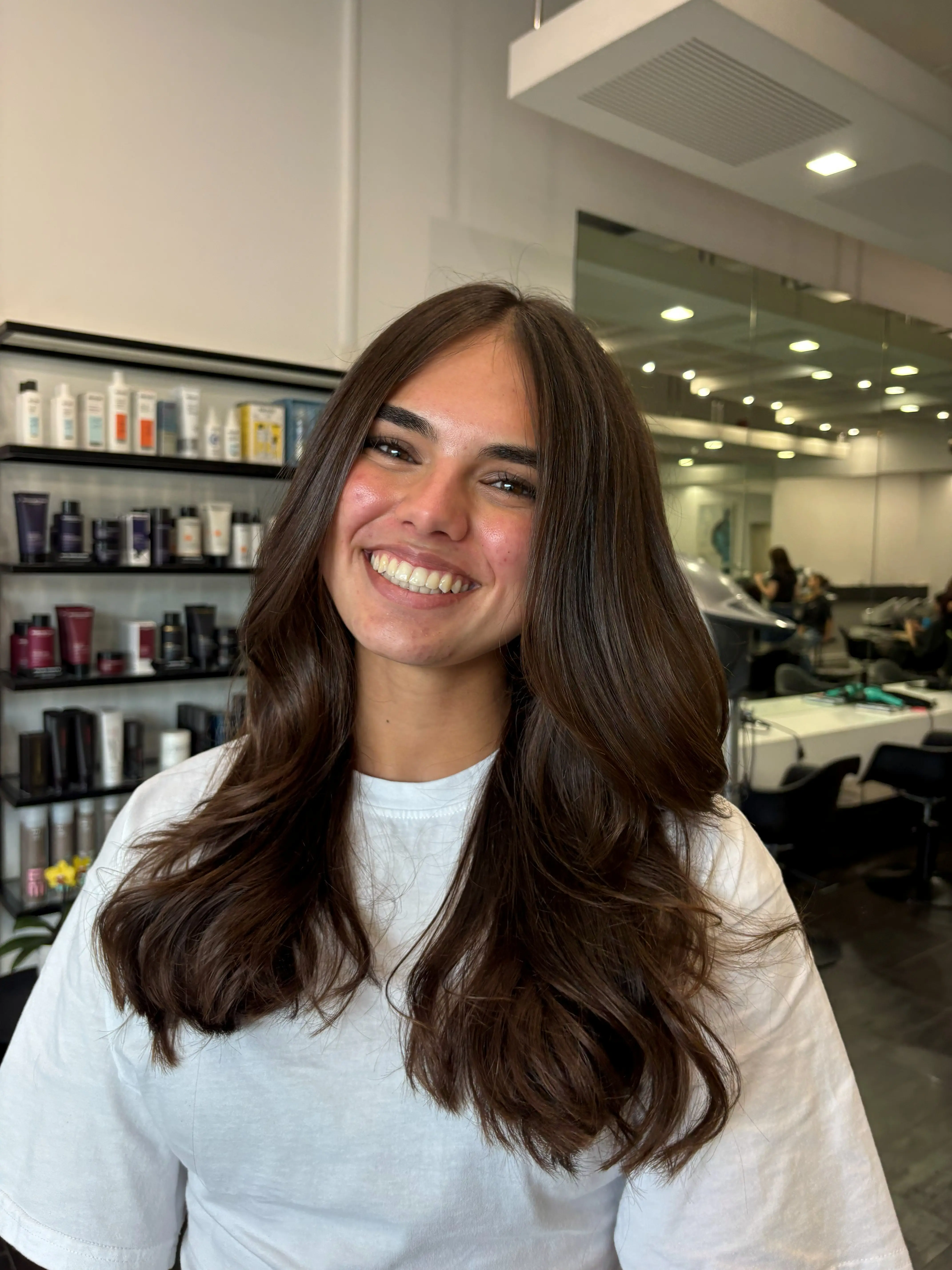 Sleek, smooth brunette hair after a keratin smoothing treatment at Salon Ayre, hair salon in Mentone VIC